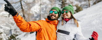 Ein Pärchen mit Sportbrillen im Schnee